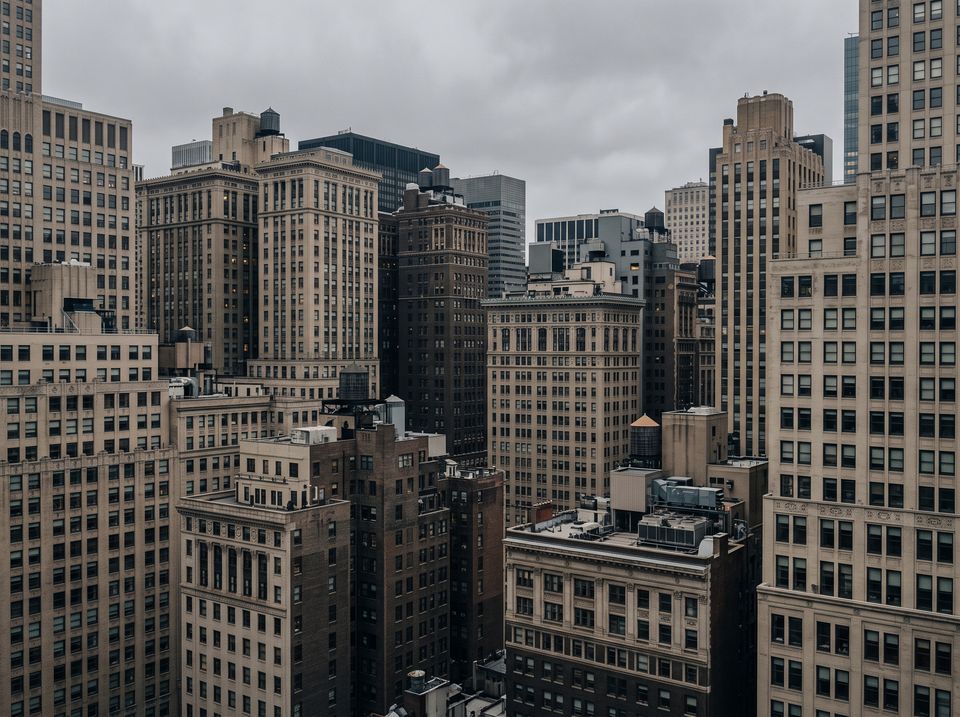Midtown Manhattan masonry office towers under an overcast sky